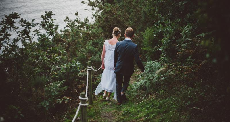 Newly weds walk down to river