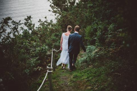 Newly weds walk down to river