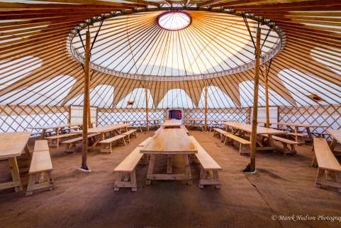 44ft yurt with simple decor and banqueting tables for 120